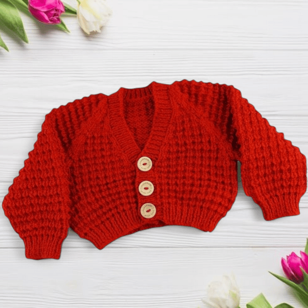 Hand knitted baby cardigan in fox red brown textured pattern 