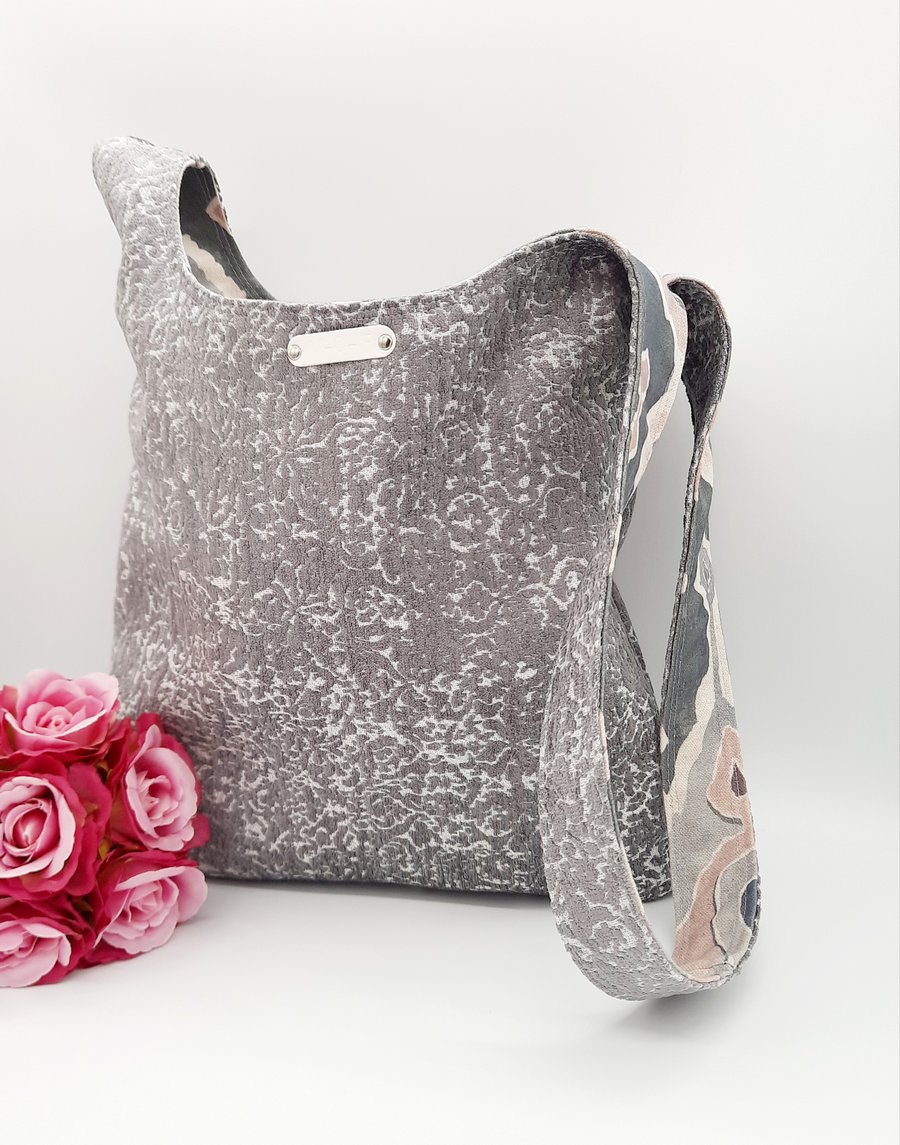 Reversible grey and patterned knot bag. 