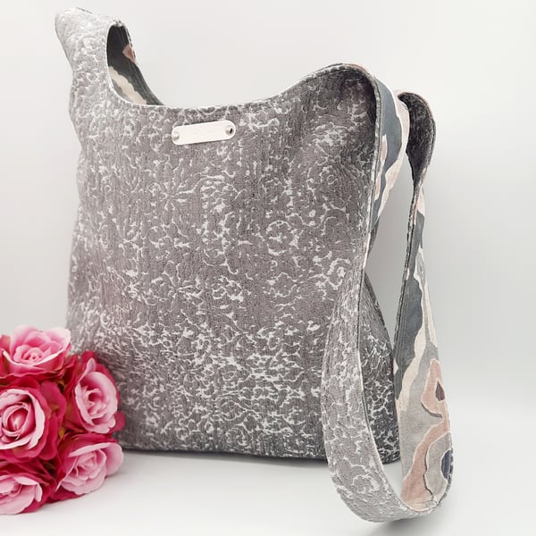 Reversible grey and patterned knot bag. 