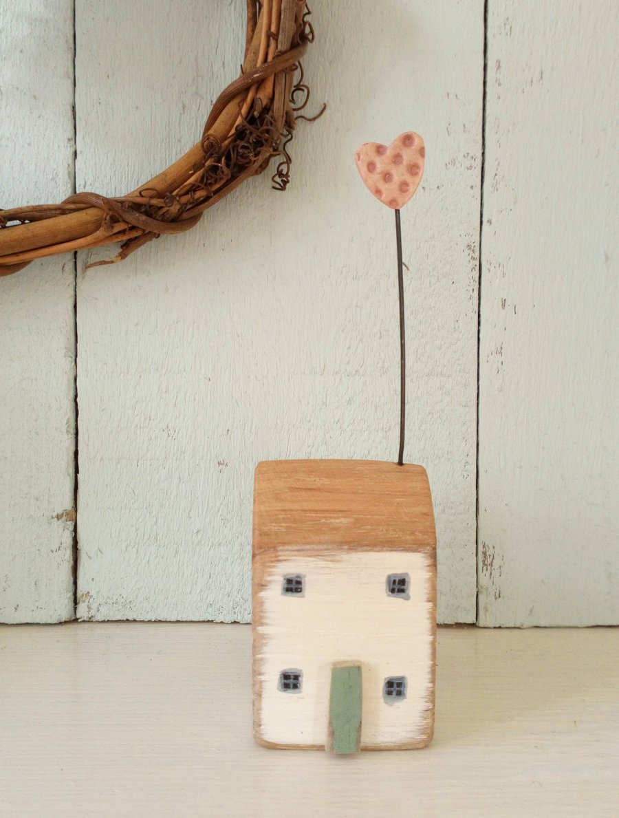 Little wooden home with a clay heart