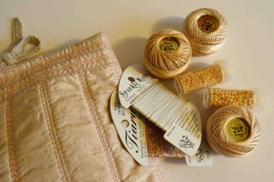 Embroidery threads and beads in a machine embroidered bag