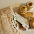 Embroidery threads and beads in a machine embroidered bag