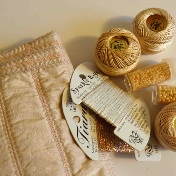 Embroidery threads and beads in a machine embroidered bag