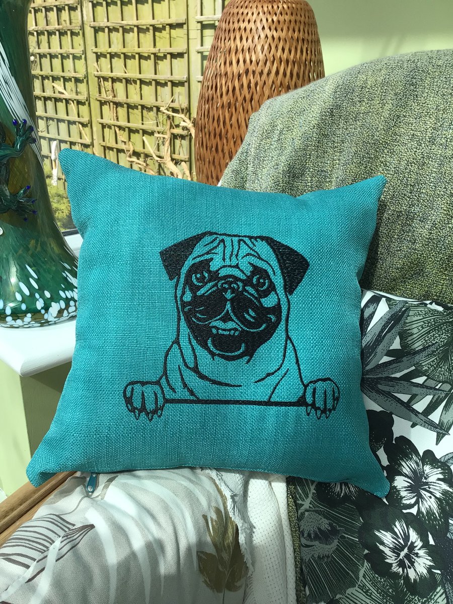 Pug embroidered cushion in teal.