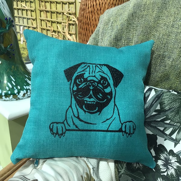 Pug embroidered cushion in teal.