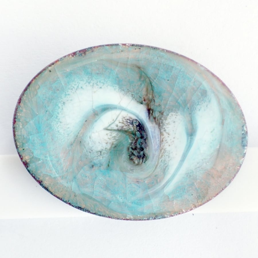 oval brooch - scrolled black and white over turquoise on clear enamel