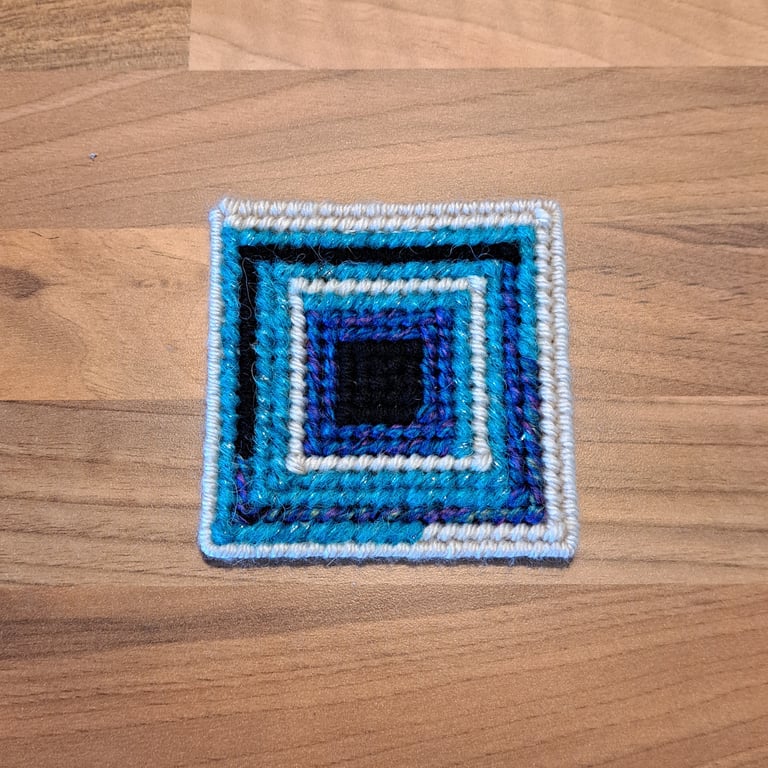 Coaster with anti-slip feet - beige, blue, and black pattern