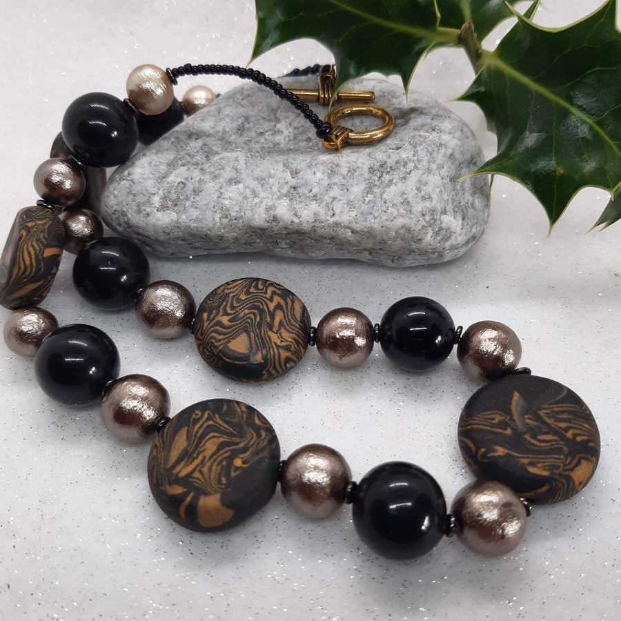 Gold and black disc shaped necklace