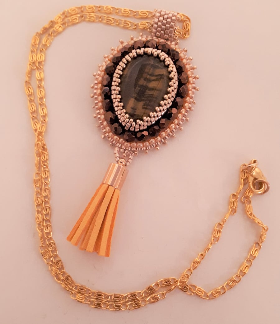 Bead embroidered teardrop Tigers Eye pendant on a gold tone chain