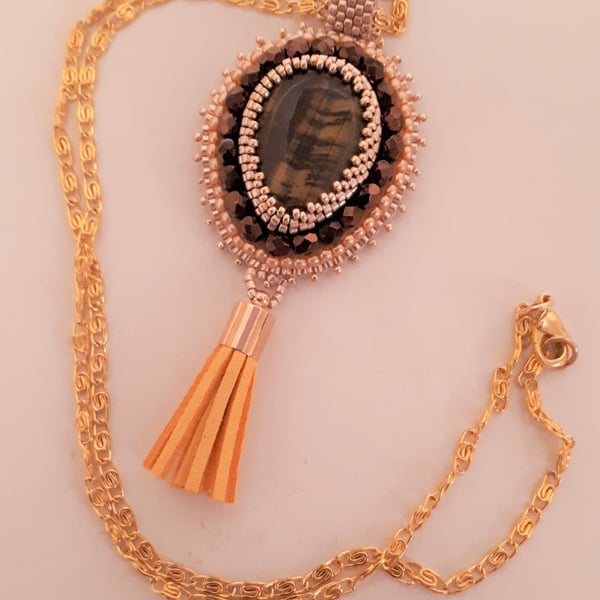 Bead embroidered teardrop Tigers Eye pendant on a gold tone chain