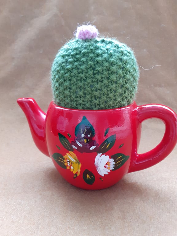 Red teapot shaped planter with knitted cactus