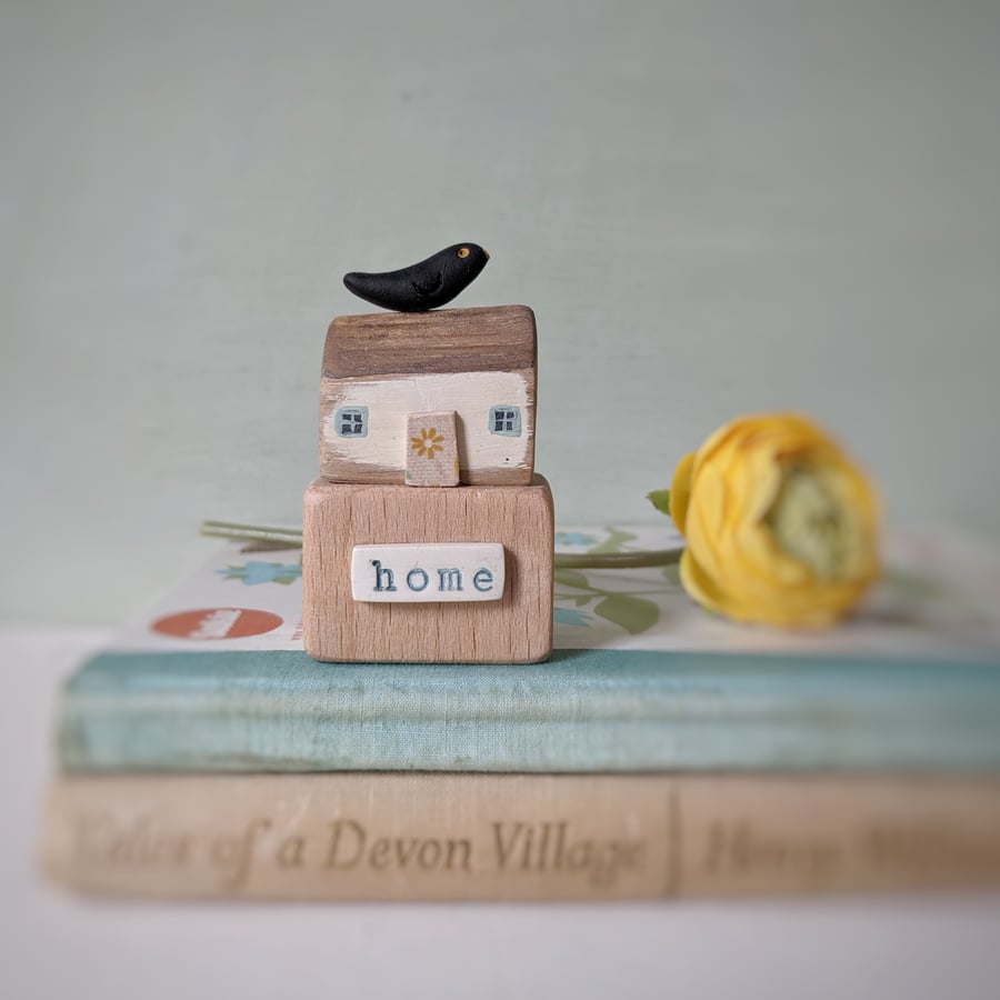 Little wooden house with clay bird 'home'