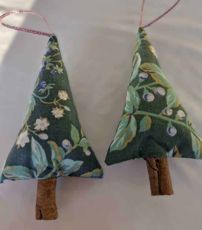 Pair of hand crafted fabric christmas tree decorations with cinnamon trunk