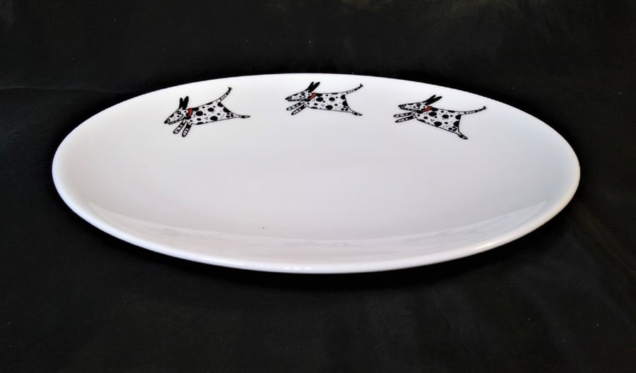 An oval shallow dish decorated with three amusing running Dalmatians. Useful as 