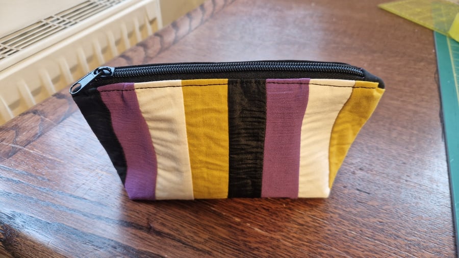 Hand sewn zip pouch made with vintage fabric.