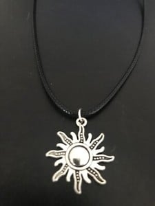 sun charm pendant on a 18" leather cord necklace