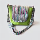 Light green messenger bag with bold colour accent.