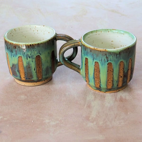Pottery mug speckled stoneware clay finished in a turquoise glaze.