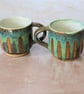 Pottery mug speckled stoneware clay finished in a turquoise glaze.