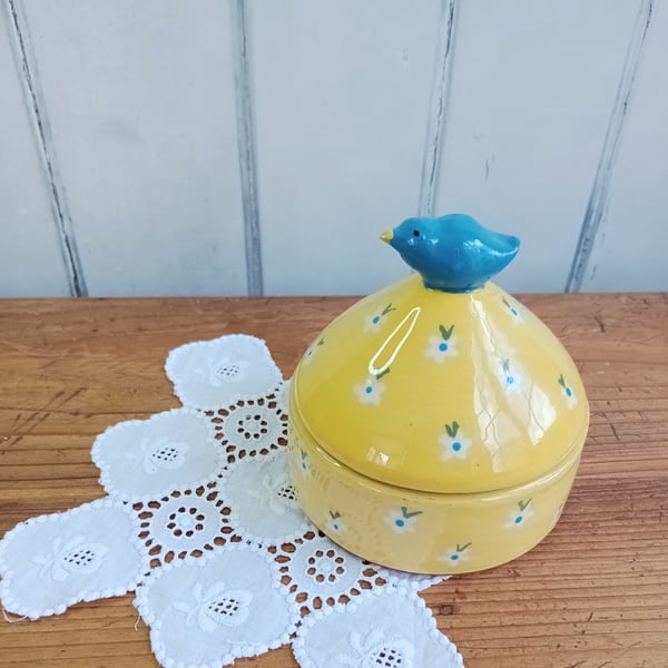 Yellow lidded pot with blue bird knob and flower design