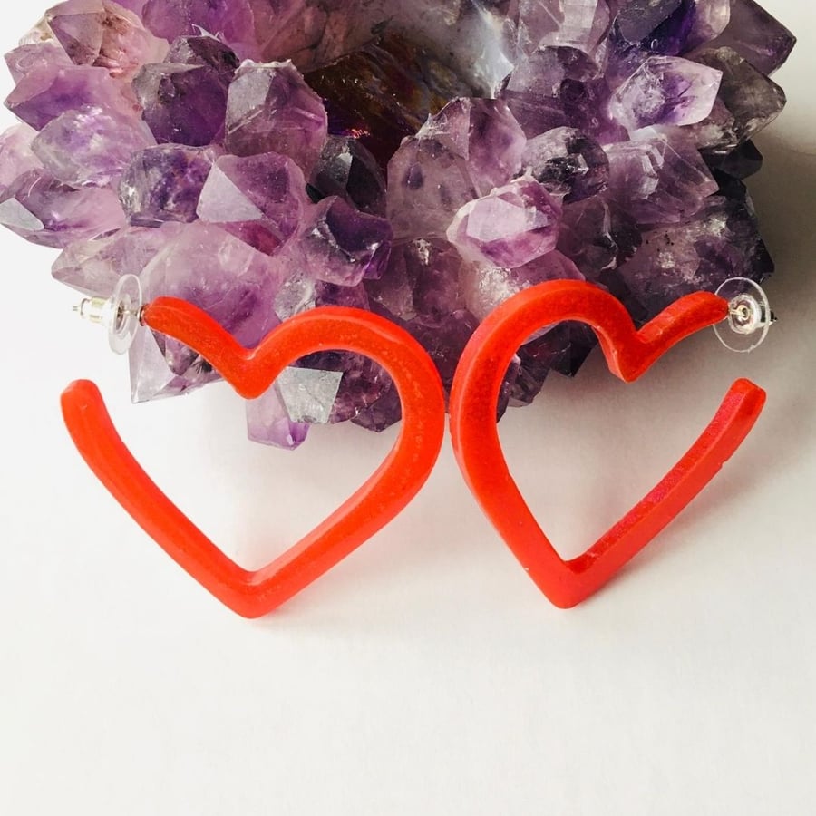 Red heart hoop statement earrings.