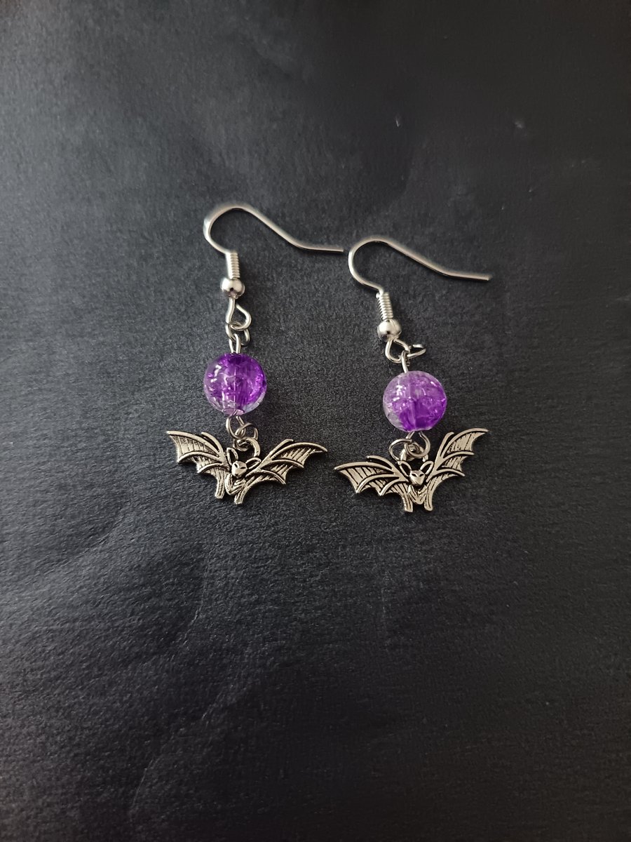 Silver bat charm and purple bead dangle earrings 