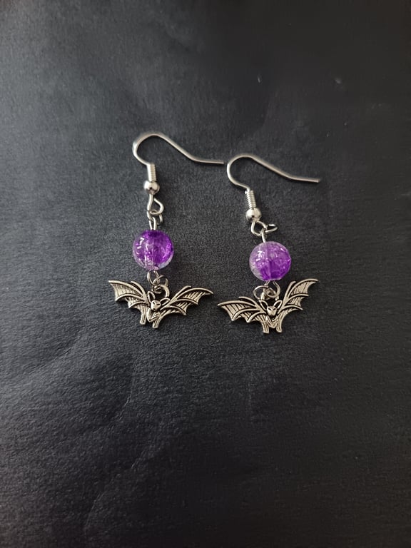 Silver bat charm and purple bead dangle earrings 