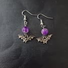 Silver bat charm and purple bead dangle earrings 