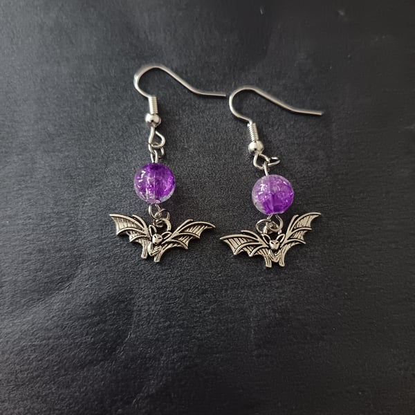 Silver bat charm and purple bead dangle earrings 