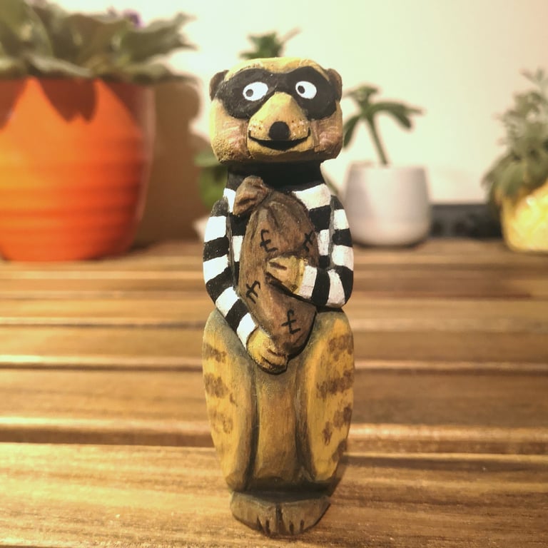 Hand carved, painted and finished wooden Reggie the Meerkat Burglar
