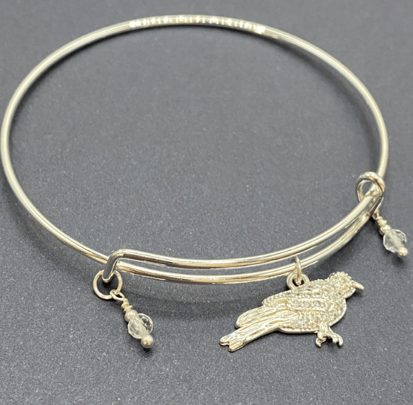 Silver plated bird charm bangle with white topaz stones