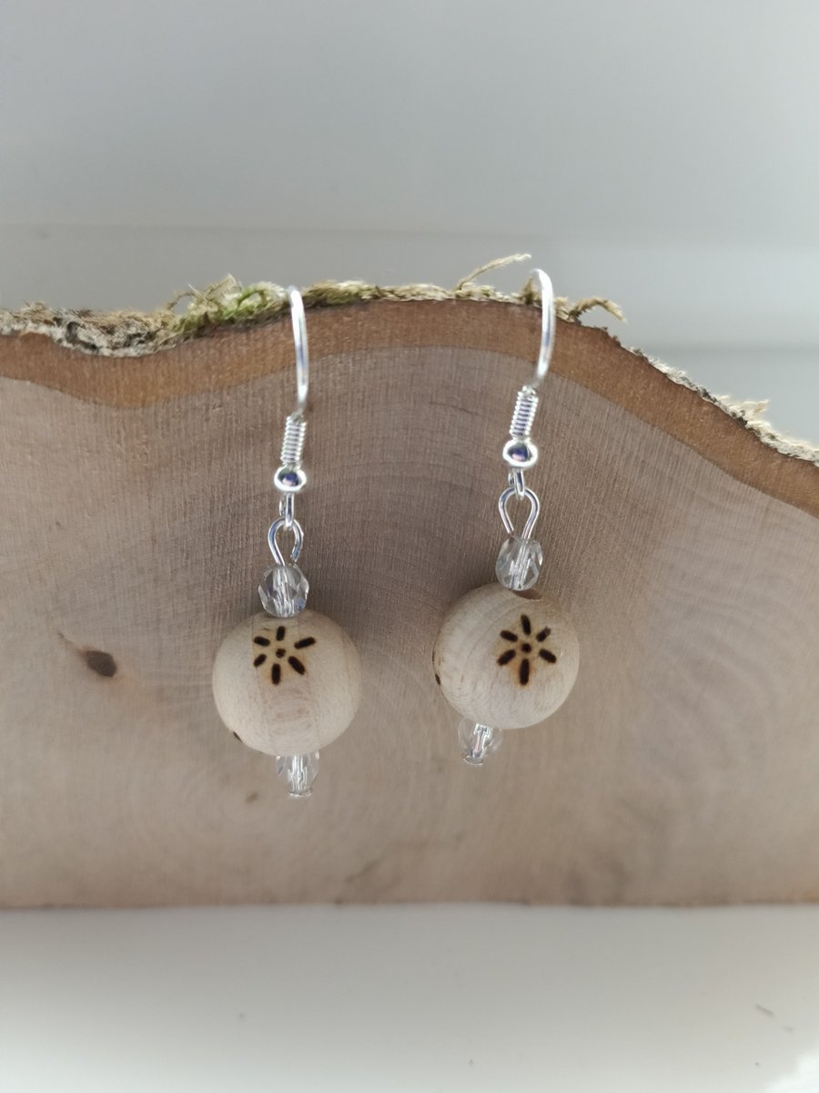 Wooden beaded dangle earrings with pyrography flowers and silver plate