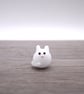 small white glass cat figure