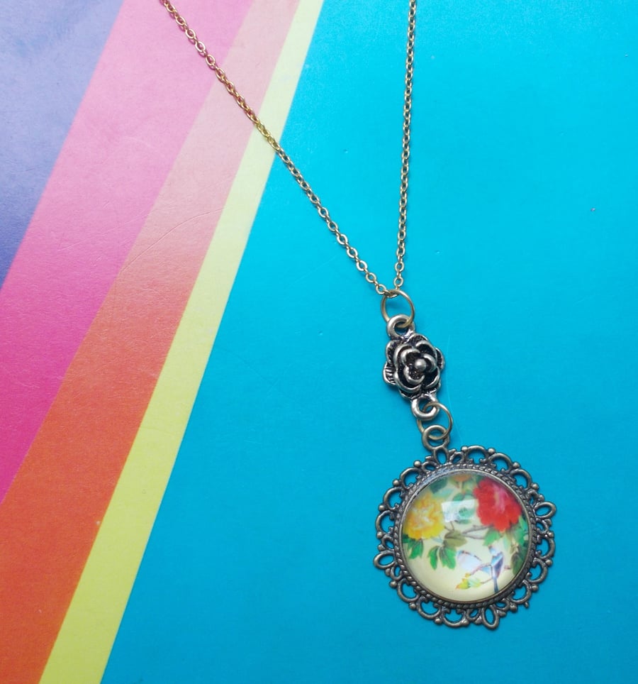 A Japanese Image of Flowers and Birds in a Glass Cabochon Pendant