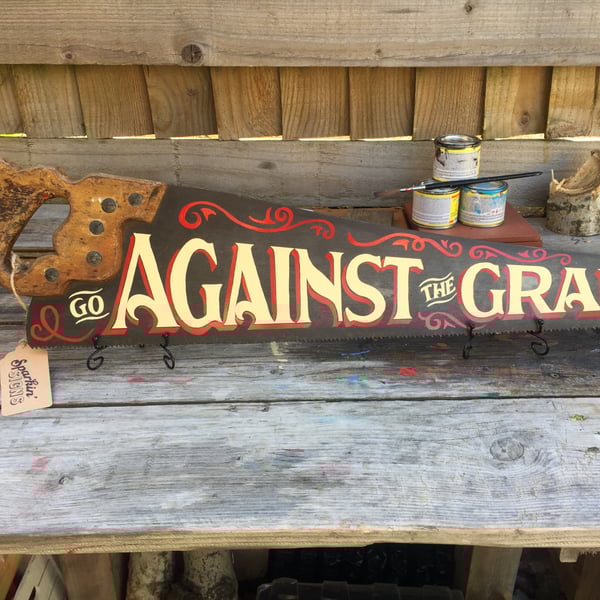 'GO AGAINST THE GRAIN' hand-painted vintage saw