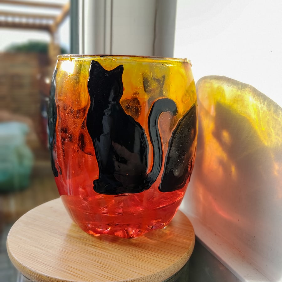 Glass painted sunset orange candle holder with black silhouettes of cats