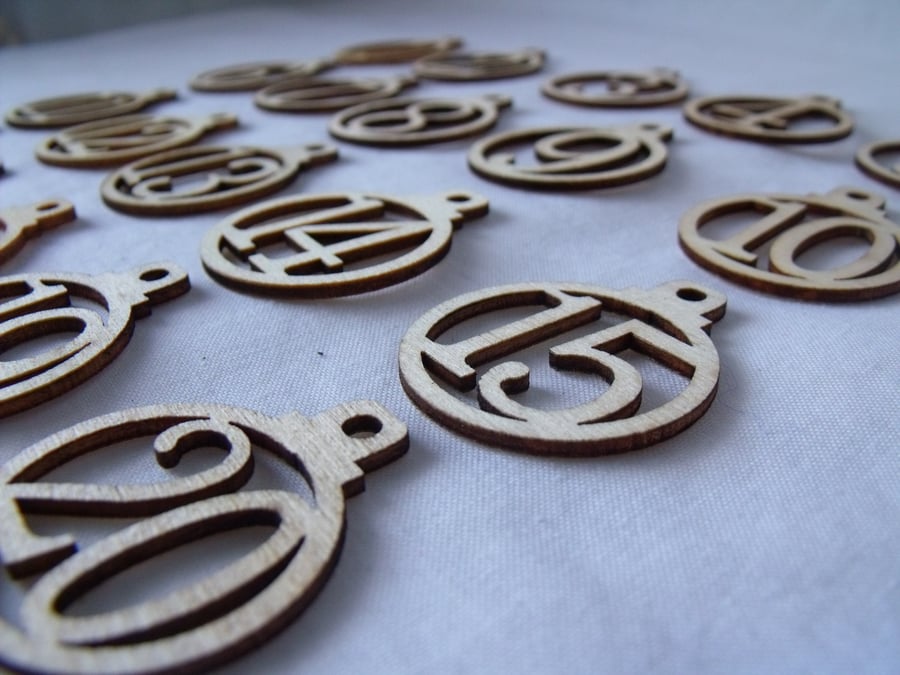 laser cut wooden christmas advent numbers in the shape of baubles