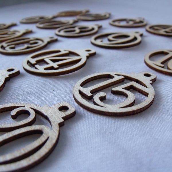 laser cut wooden christmas advent numbers in the shape of baubles