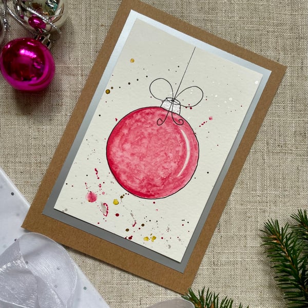Christmas card, hand painted original of a single christmas bauble in pink.