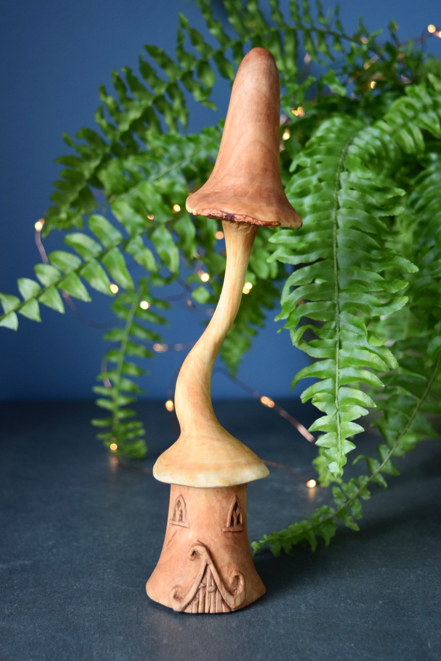Hand carved wooden fairy house with mushroom roof