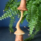 Hand carved wooden fairy house with mushroom roof