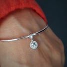 Sterling silver bangle with star charm