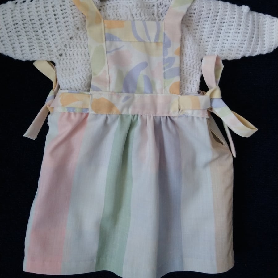 Reversible baby dress in pastel colours including a Laura Ashley print