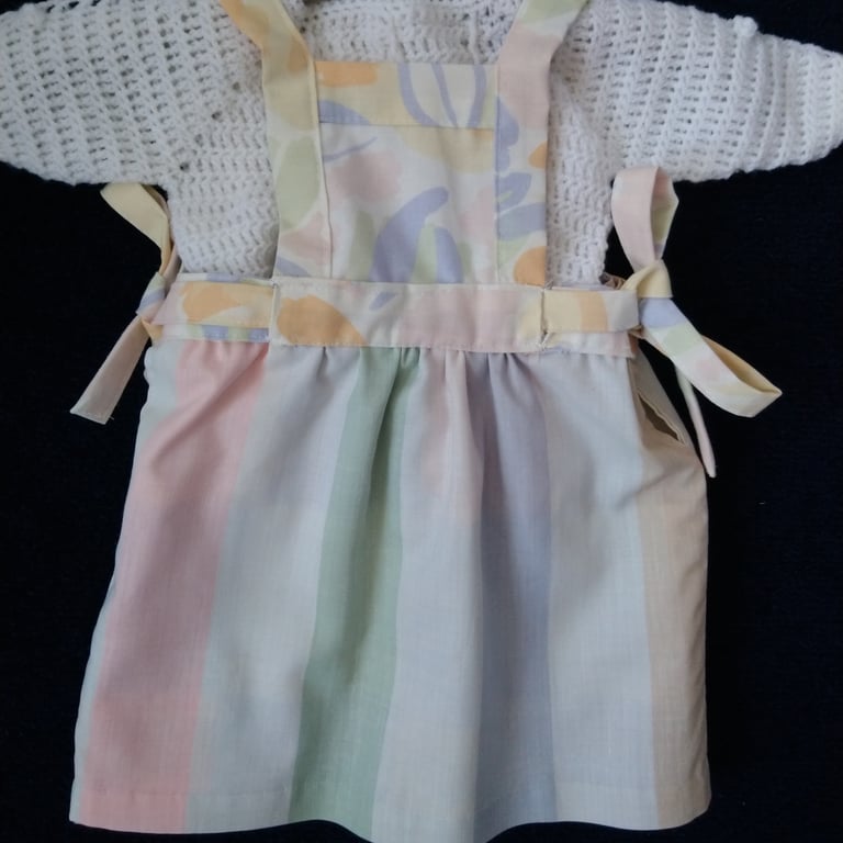 Reversible baby dress in pastel colours including a Laura Ashley print