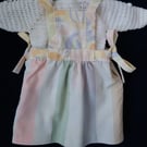 Reversible baby dress in pastel patchwork