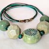Chunky green ceramic necklace on knotted cord