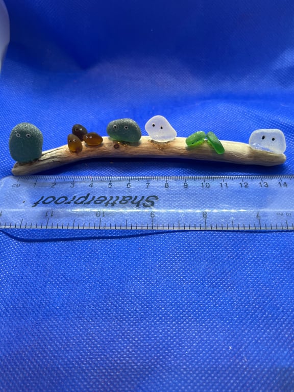 Frosted sea glass nuggets on driftwood.