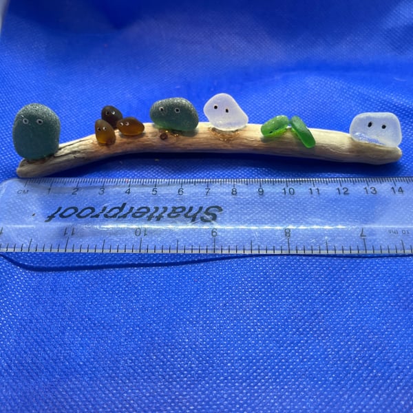 Frosted sea glass 'nuggets' on driftwood.