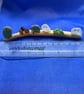 Frosted sea glass nuggets on driftwood.