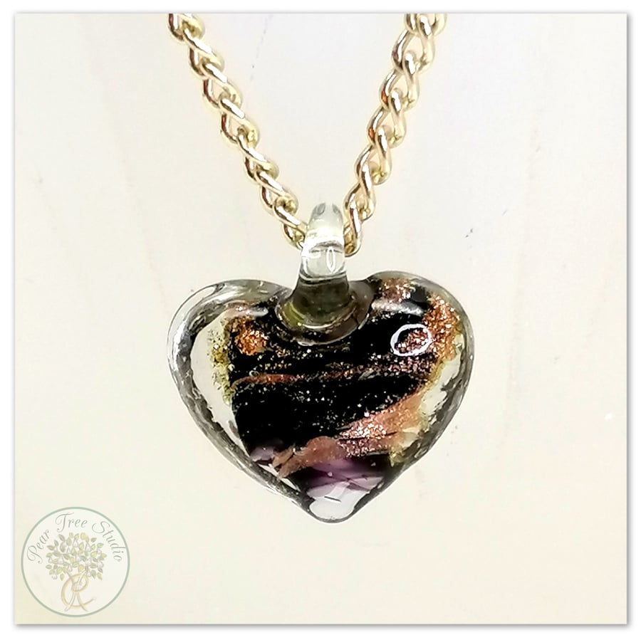 Glass heart pendant with a copper shimmer on gold plated necklace chain